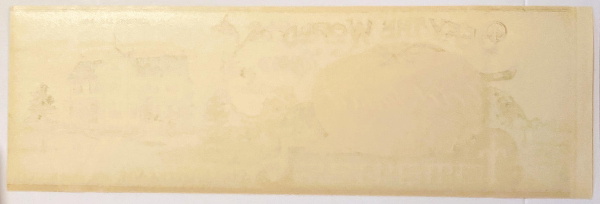 Aged cream-colored vintage tomato can label with faint printed text, showing wear and discoloration from age