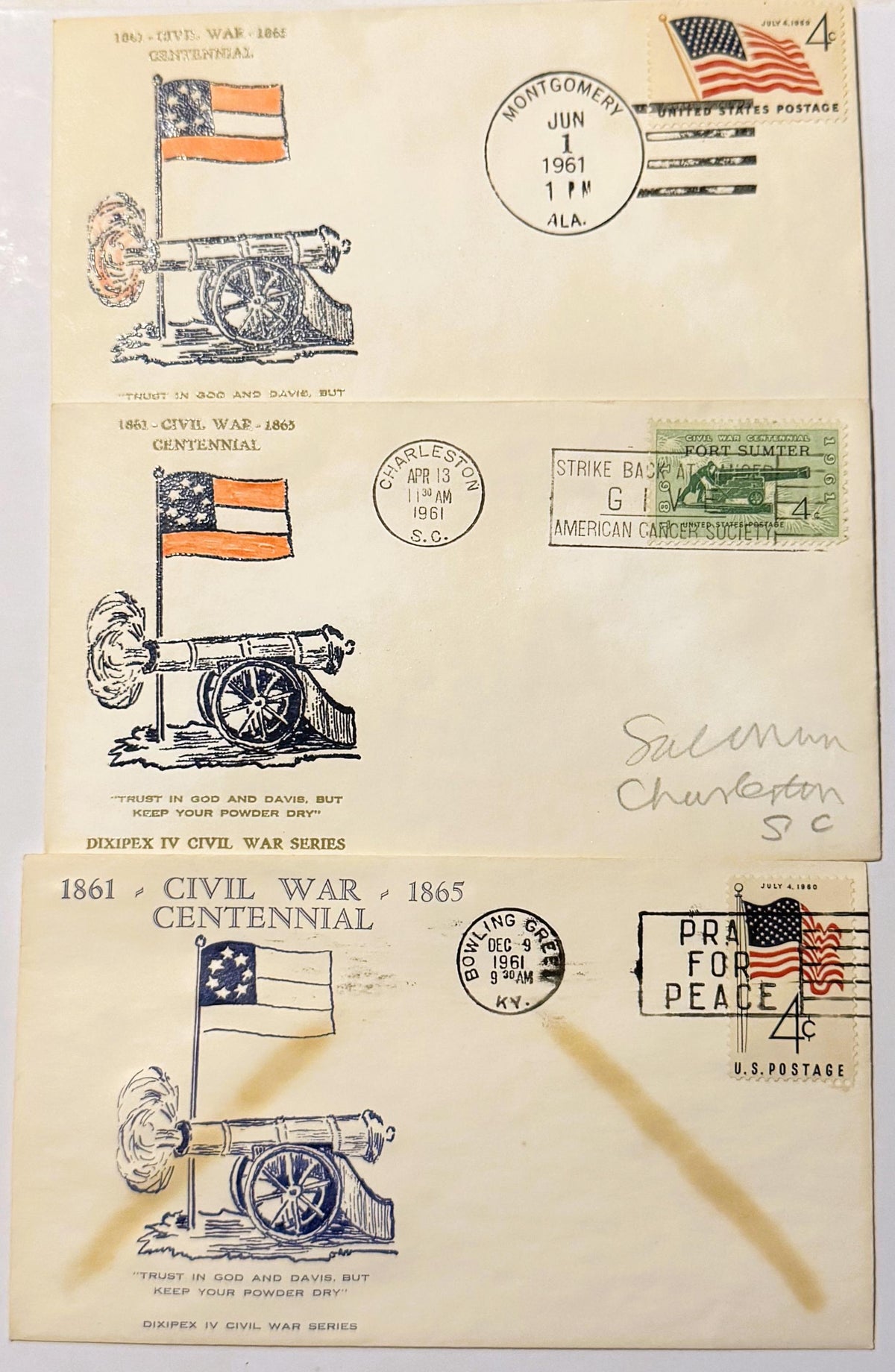 Three vintage 1961 Civil War Centennial first-day cover envelopes featuring cannon illustrations, patriotic flags, and postma