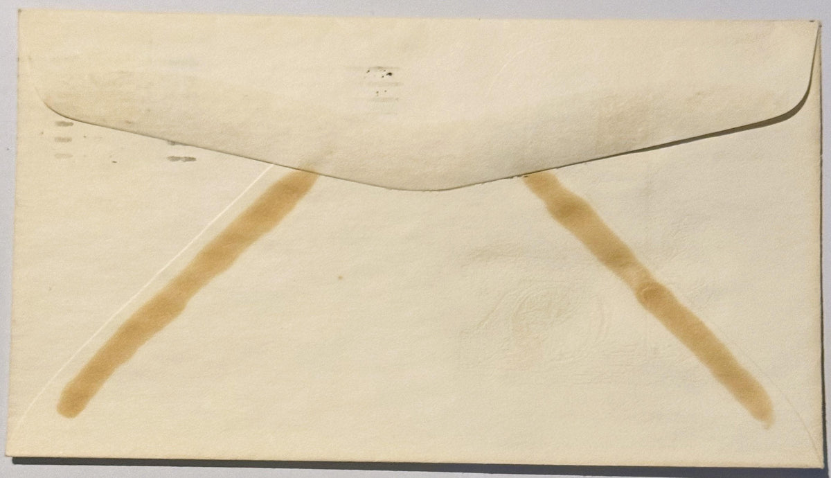 Cream-colored vintage envelope back showing triangular tan reinforcement strips and curved flap closure, photographed flat ag
