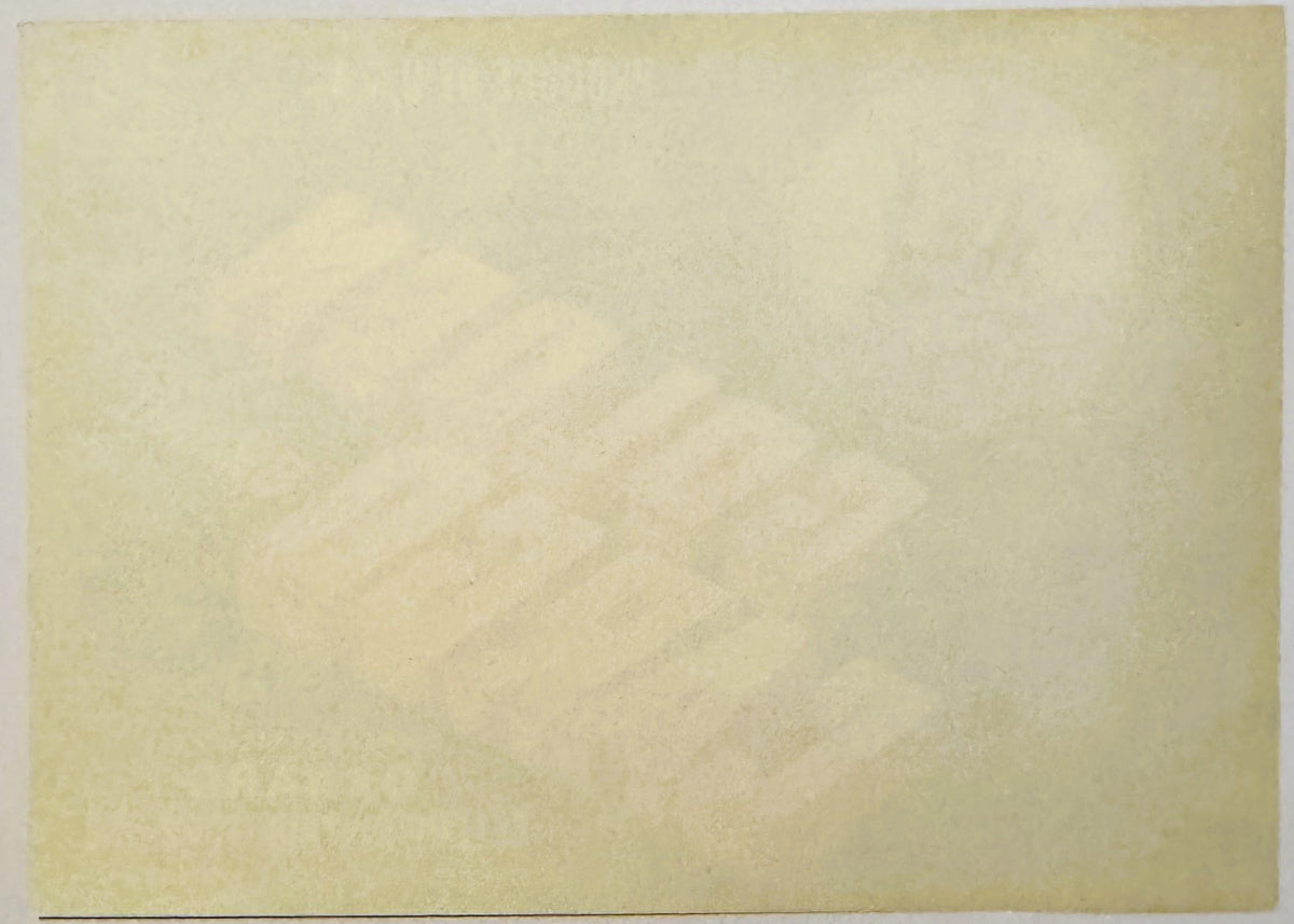 Blank cream-colored vintage crate label with faint watermark design, photographed flat against white background