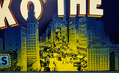 Vintage fruit crate label showing nighttime cityscape with illuminated buildings in yellow and blue, partial text "TALK O' TH