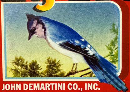 Vintage fruit crate label featuring a blue jay perched on a branch with green foliage, red border, yellow crescent moon, and 