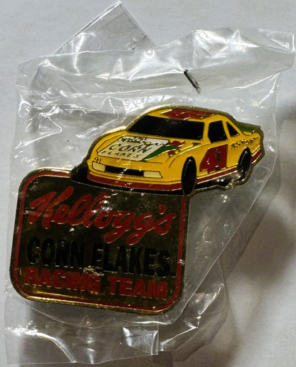 Vintage Kellogg's Corn Flakes NASCAR #41 racing pin in plastic packaging, featuring yellow race car on red rectangular base w
