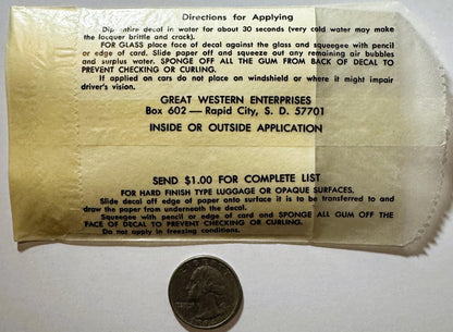 Vintage decal instruction sheet with quarter for scale, yellowed paper showing application directions from Great Western Ente