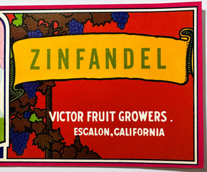 Vintage Zinfandel crate label with yellow banner, red background, and blue grape clusters, text reads "Victor Fruit Growers, 