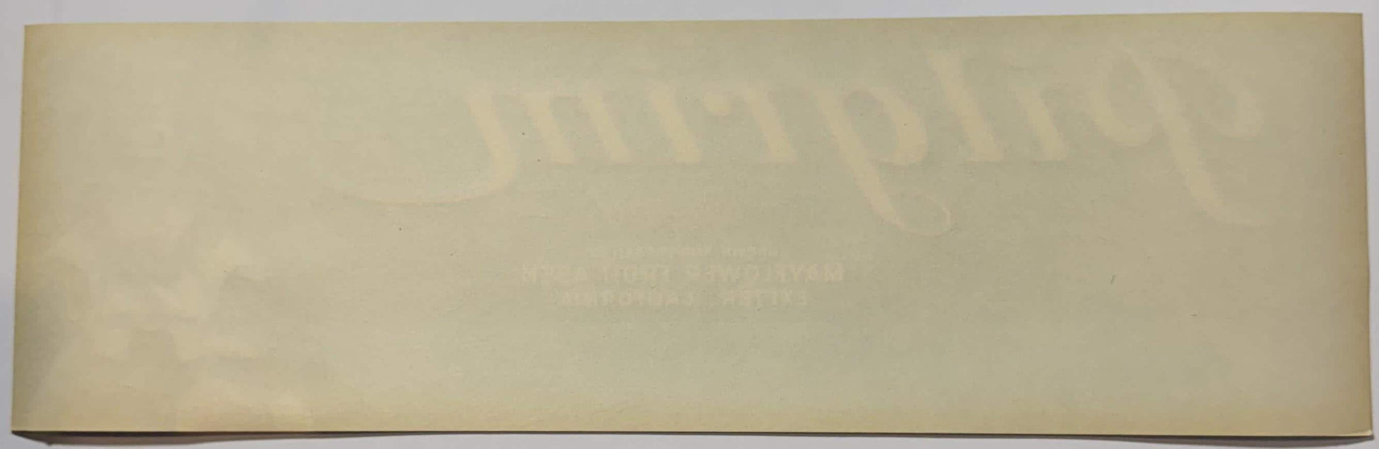 Cream-colored vintage crate label with faded embossed text and imagery, shown flat against neutral background