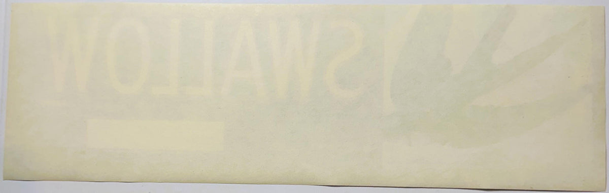 Cream-colored vintage crate label with faint printed text, photographed flat against a light background
