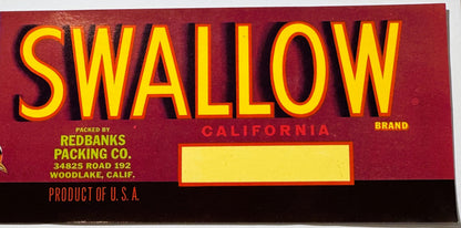 Vintage Swallow Brand fruit crate label with yellow text on red background, packed by Redbanks Packing Co.
