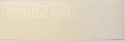 Cream-colored vintage fruit crate label with faint printed design, photographed flat against neutral background