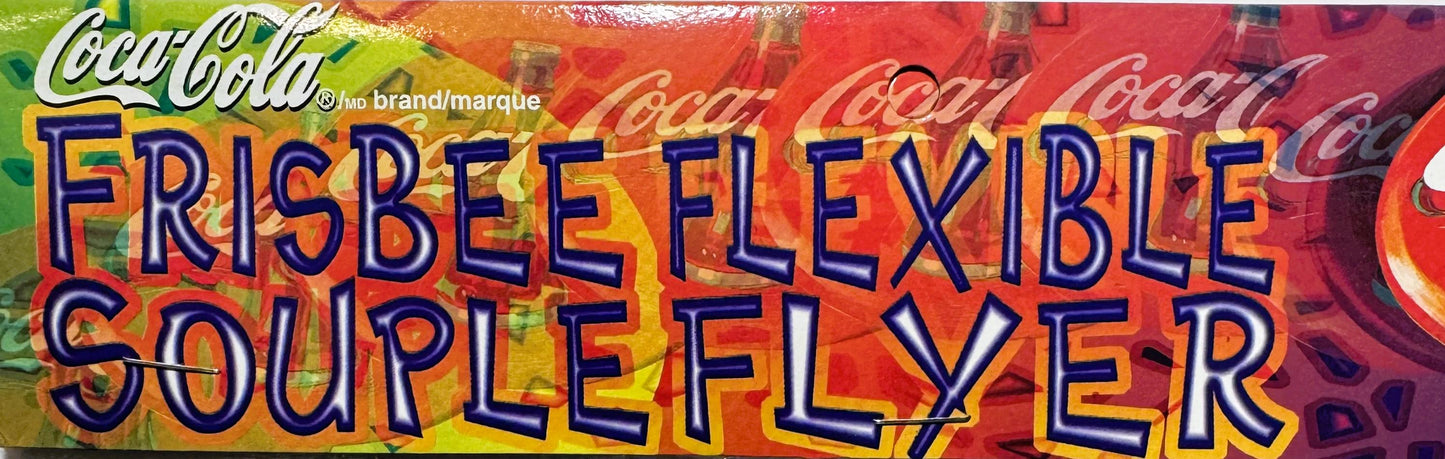 Colorful Coca-Cola Flexible Flyer promotional disc with blue and yellow text on red and green background, showing Coca-Cola b