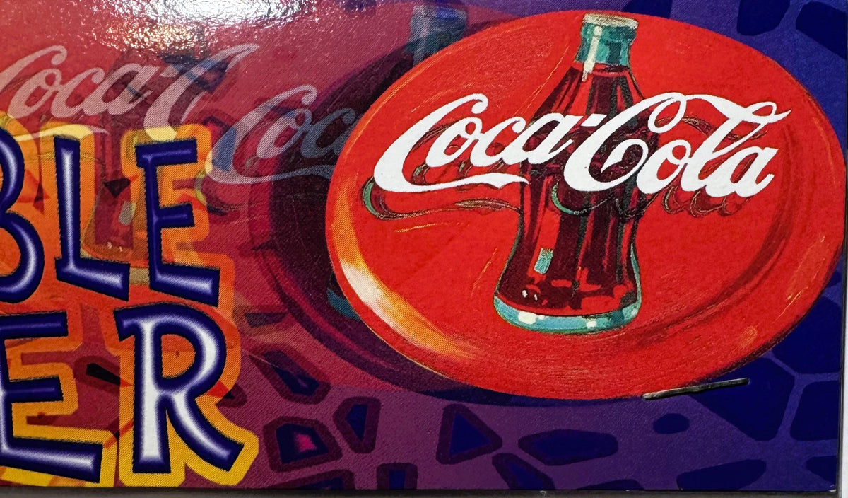 Vintage red Coca-Cola promotional disc with white logo and bottle design, displayed against purple background with partial or