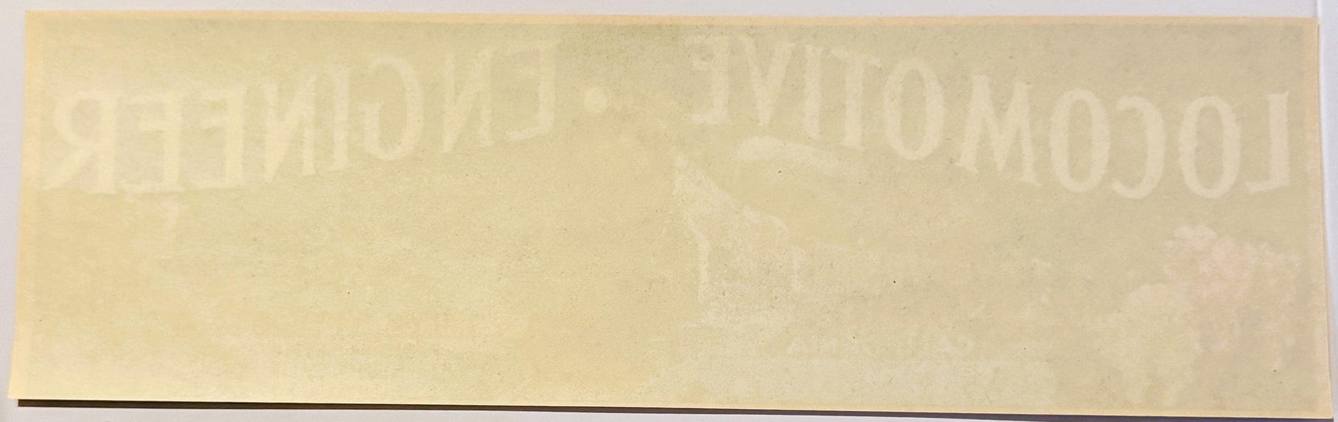 Faded cream-colored vintage crate label with embossed text reading "FRESNO" and partial locomotive imagery, showing age and w