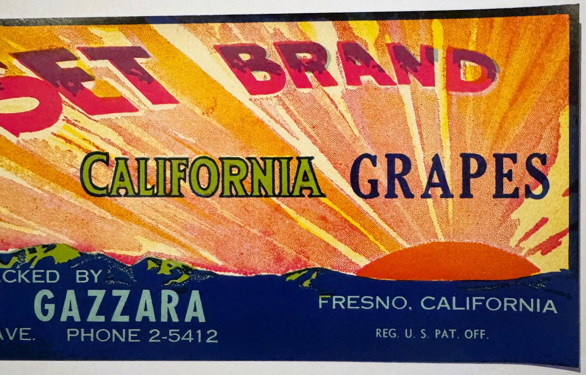 Vintage Sunset Brand California Grapes crate label with radiating sunburst design, packed by Gazzarra in Fresno, phone number