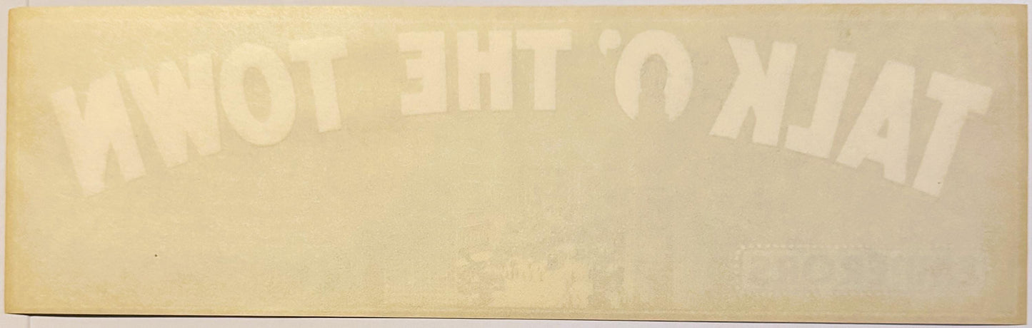 Faded vintage crate label with "Talk O' The Town" and "2" visible in embossed text on cream-colored paper, photographed flat