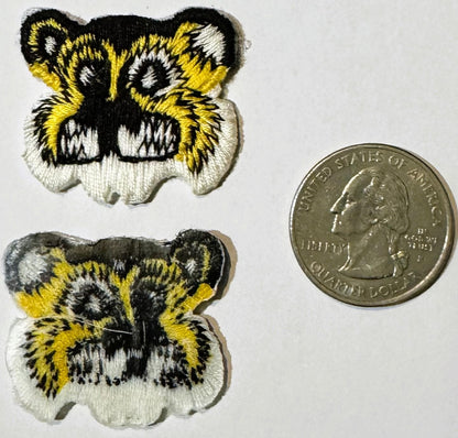 Two embroidered tiger face patches in yellow, black and white next to a US quarter dollar coin for scale.