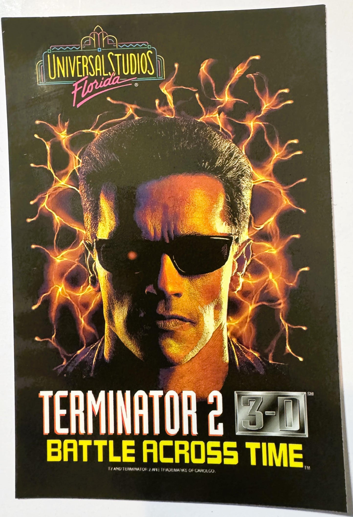 Vintage postcard for Terminator 2: 3-D attraction at Universal Studios Florida, featuring a man's face with sunglasses surrou
