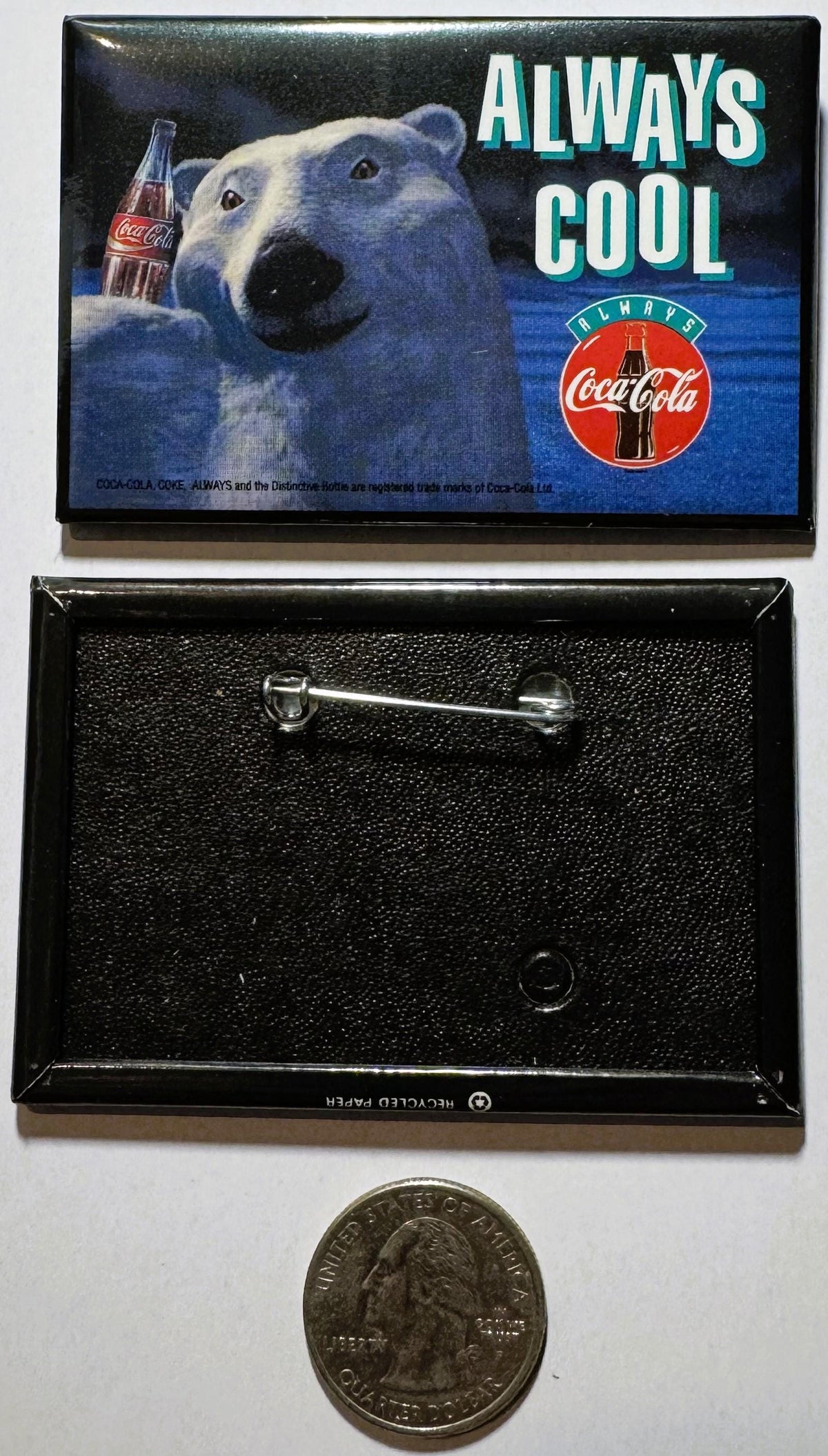 Coca-Cola polar bear enamel pin with "Always Cool" text, shown front and back with quarter for scale