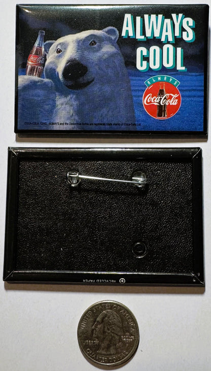 Coca-Cola polar bear enamel pin with "Always Cool" text, shown front and back with quarter for scale