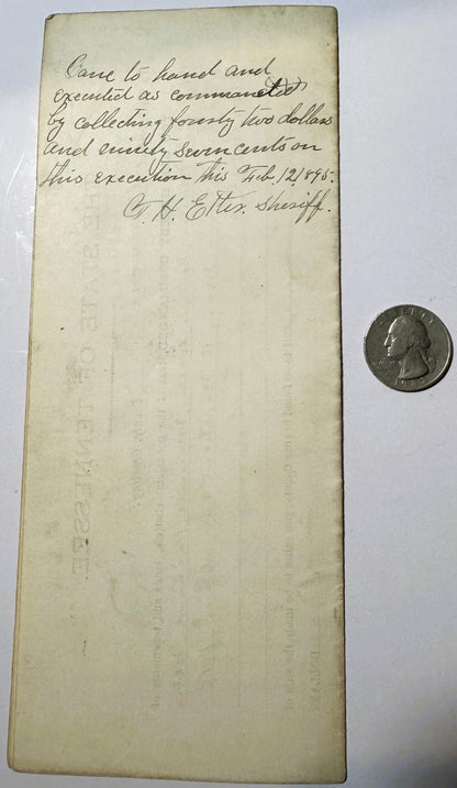 Handwritten 1893 Tennessee legal document with quarter coin for scale, yellowed paper showing cursive text