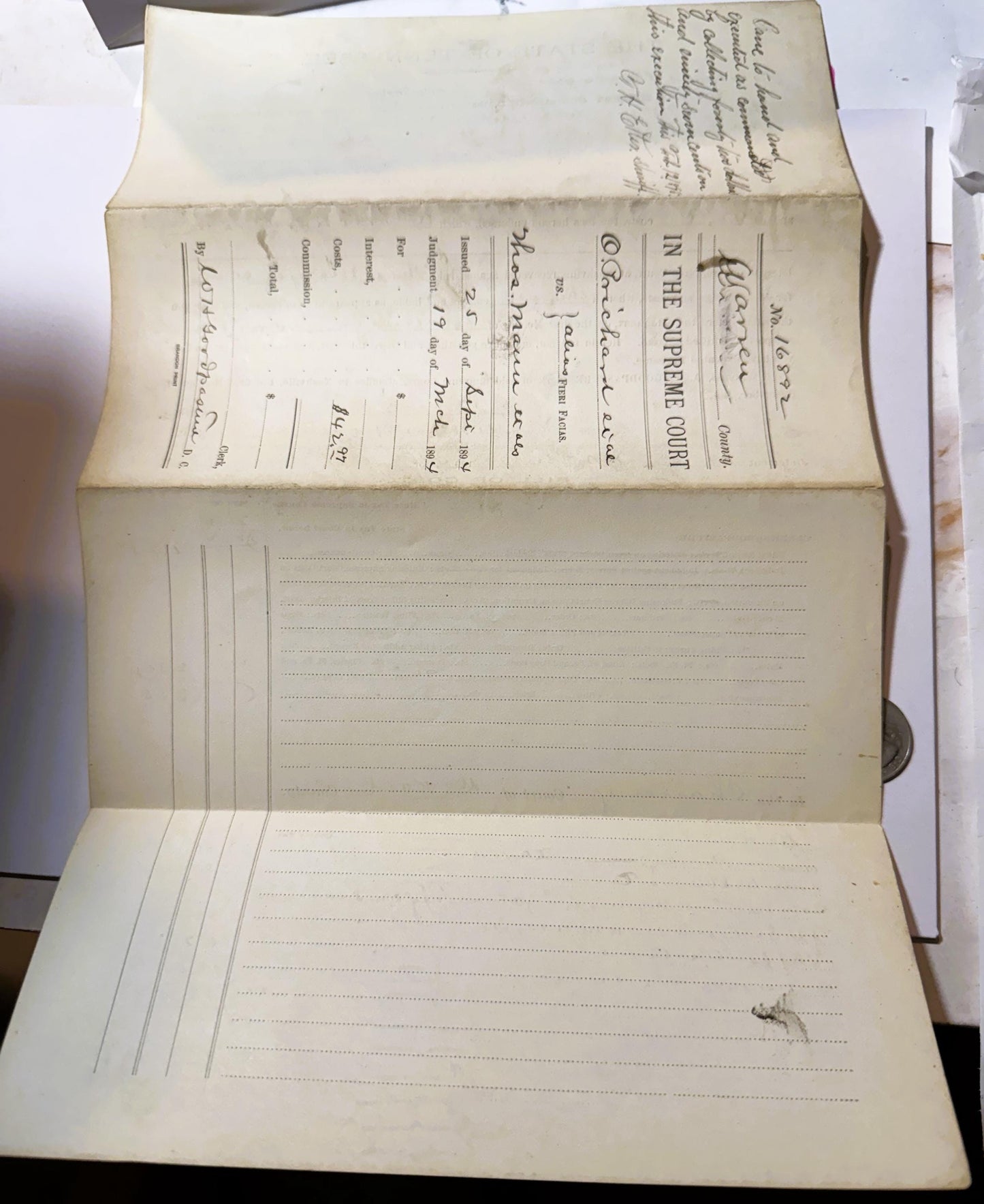 Opened antique legal document showing yellowed pages with handwritten text at top and printed form with dotted lines below, d