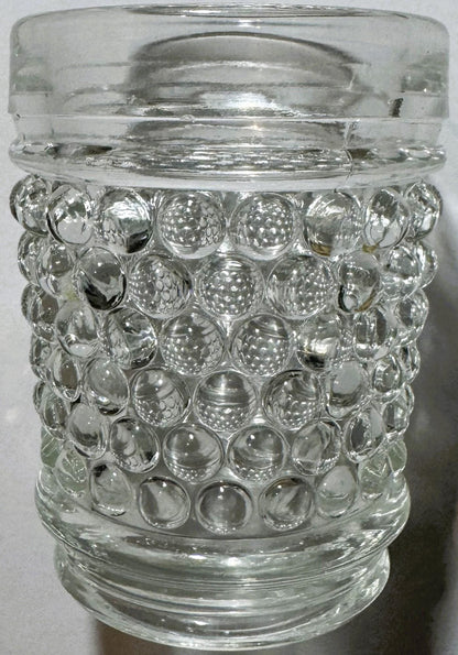 Clear glass hobnail tumbler with bubble texture, shown straight-on against white background, glass lid visible at top.
