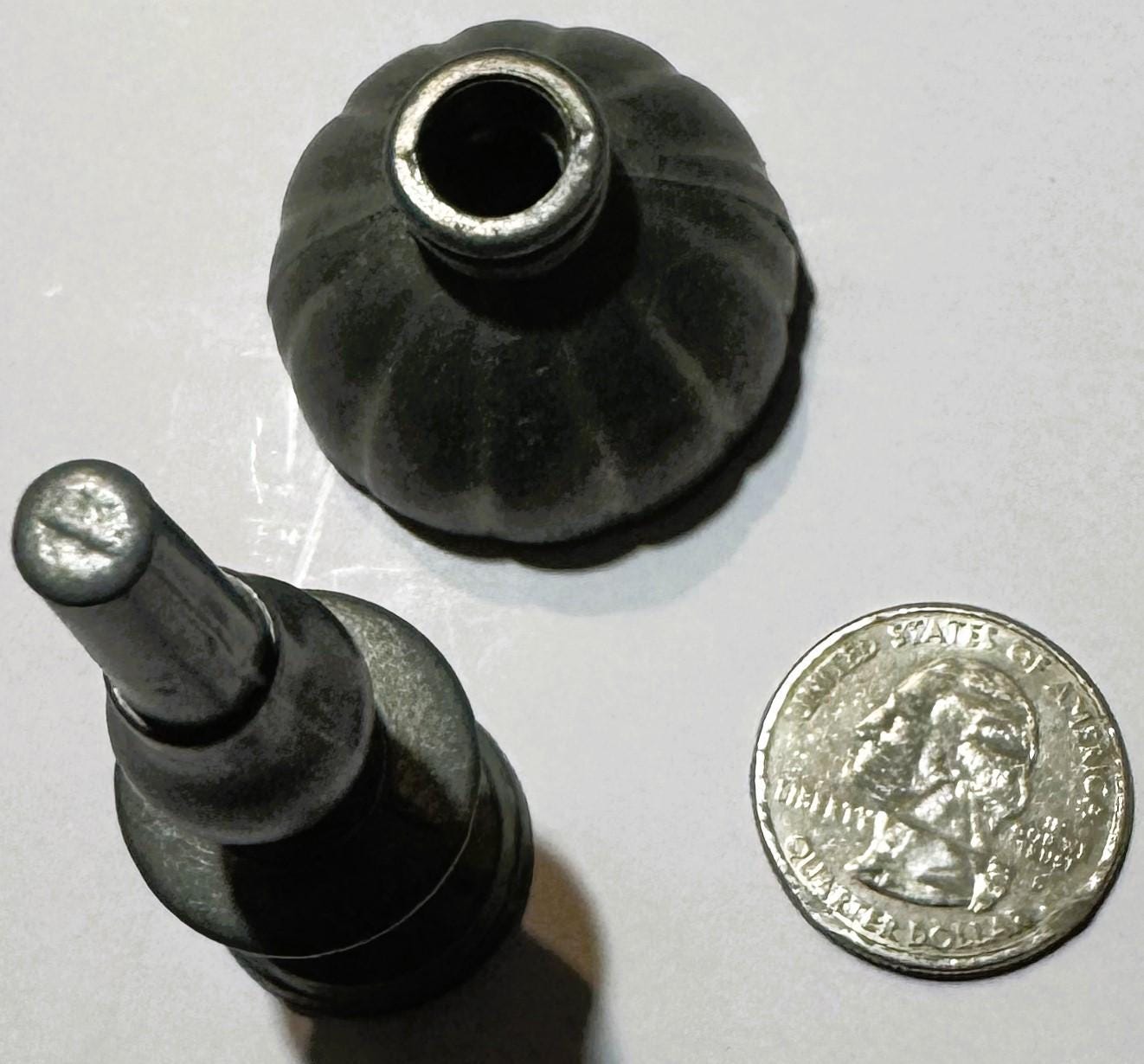 Vintage pewter goblet with fluted bowl and baluster stem shown from above next to a quarter for scale