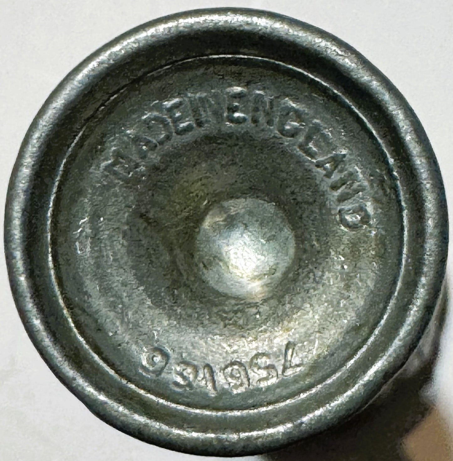 Close-up of the underside of the base showing embossed text reading MADE IN ENGLAND above a worn stamped mark