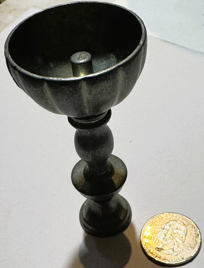 Vintage pewter miniature goblet with fluted bowl and baluster stem next to a British pound coin for scale