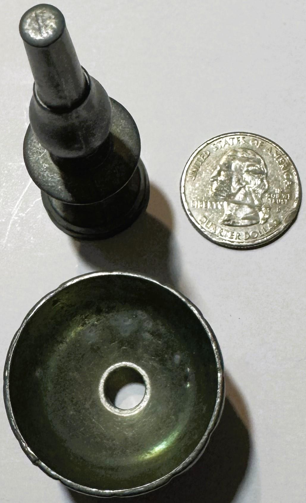 Miniature pewter goblet with fluted bowl and baluster stem next to US quarter coin for scale, showing size and detail