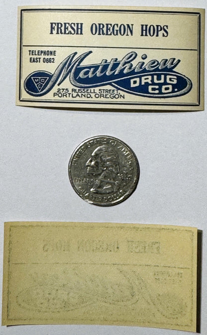 Vintage label for Matthew Drug Co., Portland Oregon advertising fresh hops, with quarter coin and reverse side shown for scal