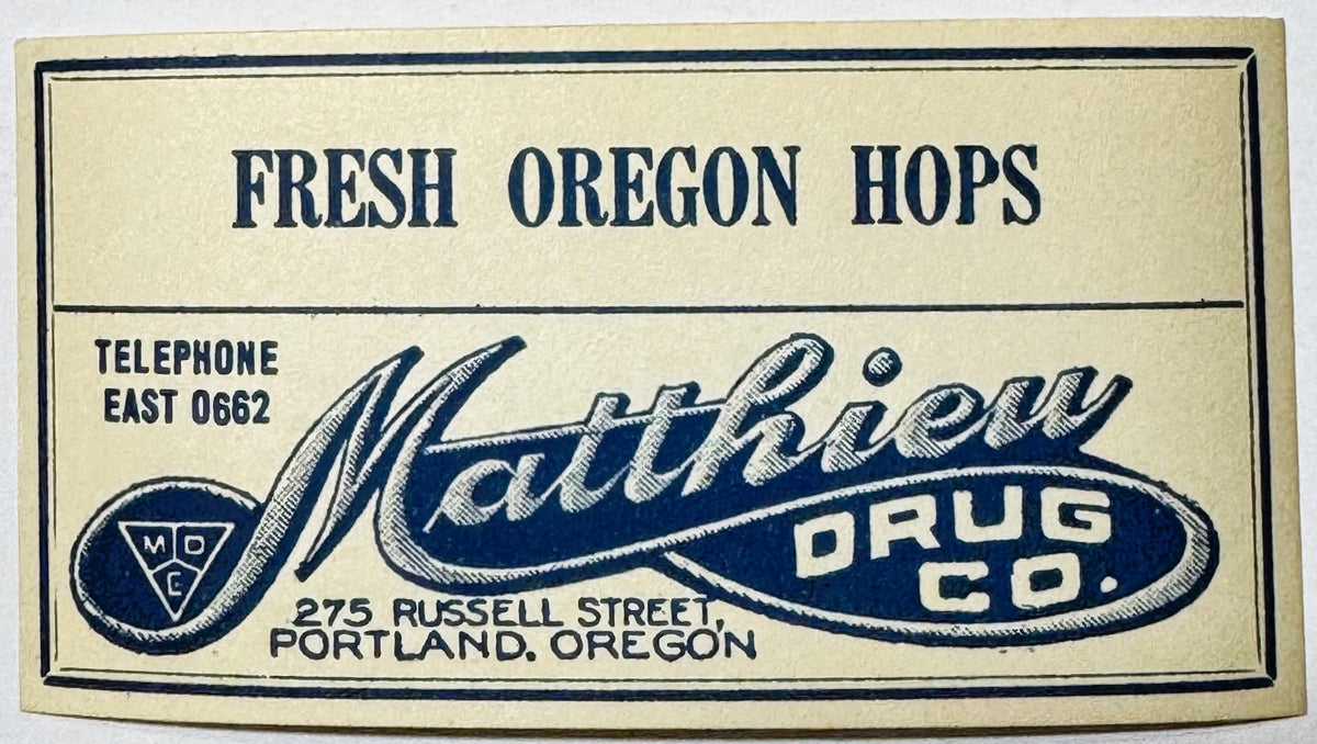 Vintage rectangular drug store label with navy and cream colors, featuring Matthew Drug Co. branding and hop imagery, Portlan
