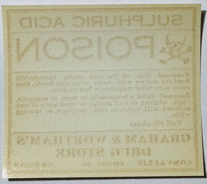 Cream-colored embossed poison label from Corvallis Oregon pharmacy reading "SULPHURIC ACID 1910s" with faded text below, phot