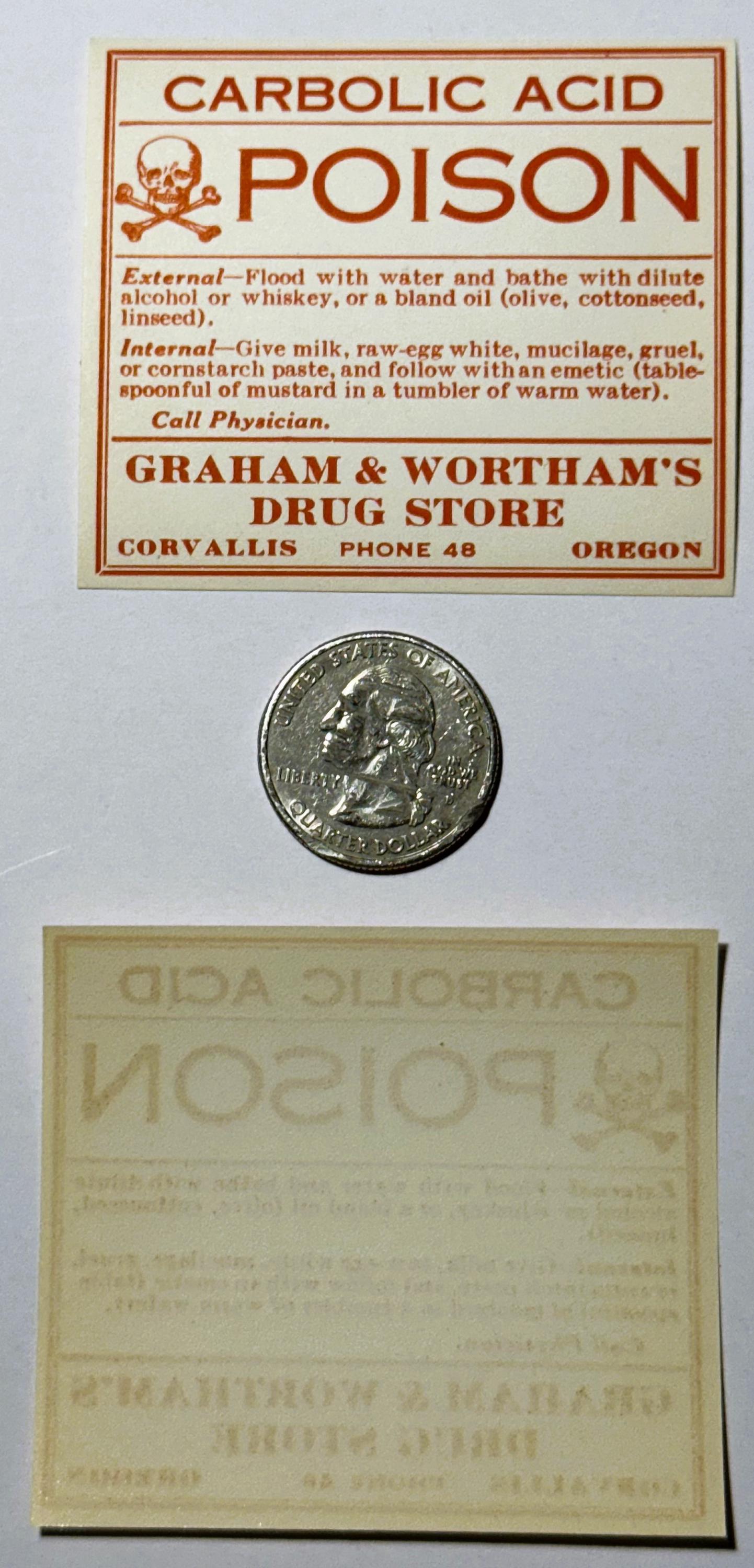 Vintage poison warning label for carbolic acid from Graham & Wortham's Drug Store in Corvallis, Oregon, displayed with a quar