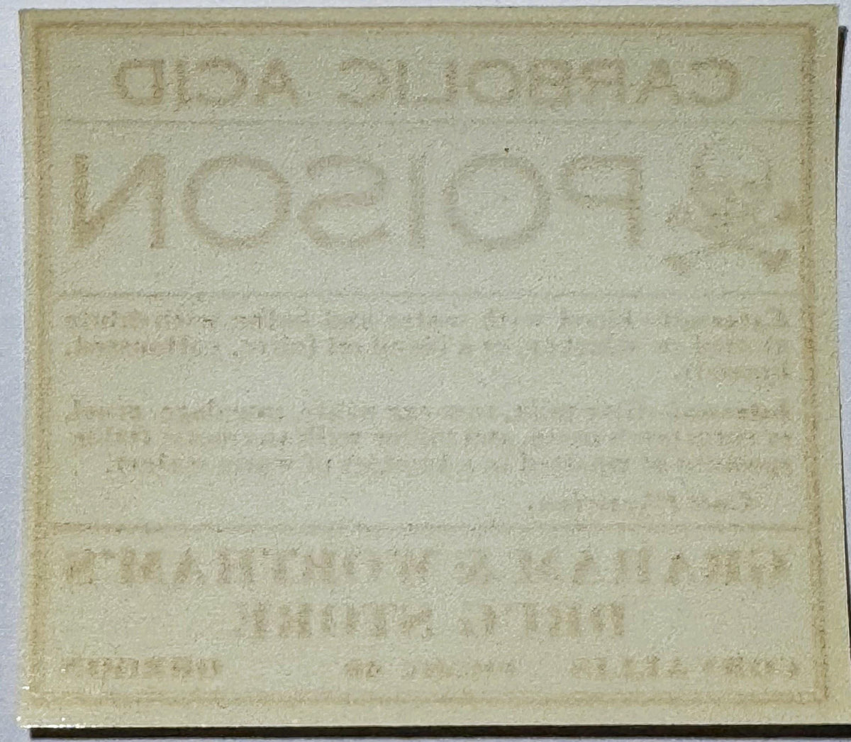Cream-colored antique poison label with embossed text reading "CARBOLIC ACID" and "Graham & Worthams Drug Store, Corvallis OR