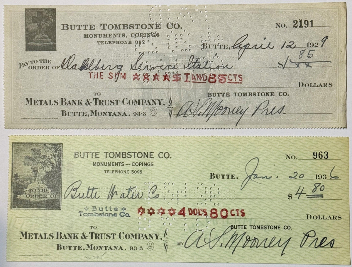 Two vintage Butte Tombstone Company checks from 1920s-1930s Montana on cream and pale green paper with monument imagery and h