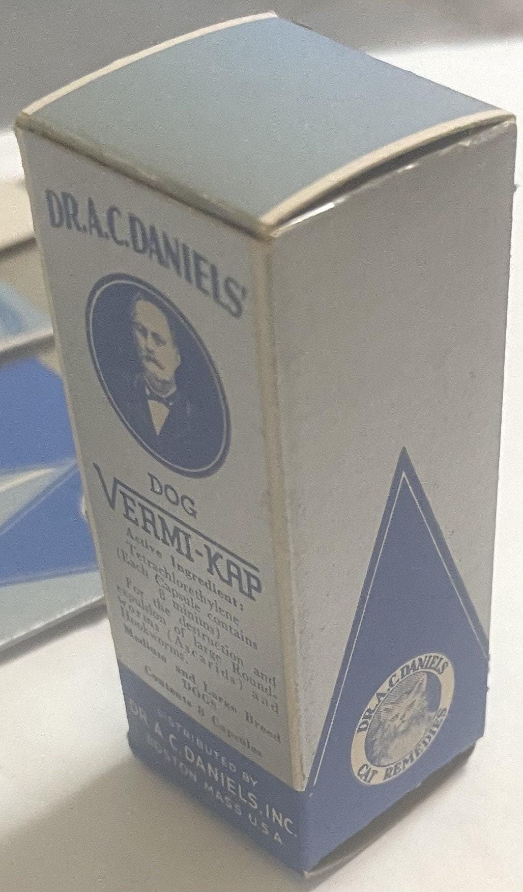 Vintage white and blue cardboard medicine box for Dr. A.C. Daniels Dog Vermi-Kap, featuring a portrait medallion