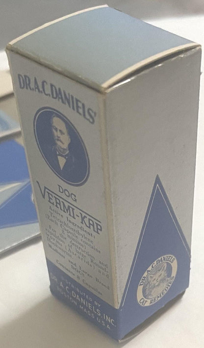 Vintage white and blue cardboard medicine box for Dr. A.C. Daniels Dog Vermi-Kap, featuring a portrait medallion