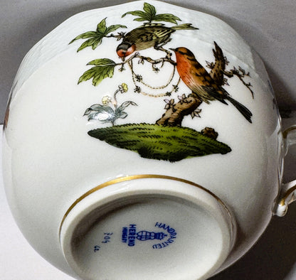 Herend porcelain teacup with hand-painted bird perched on branch among leaves and flowers, gilt rim, maker's mark visible on 