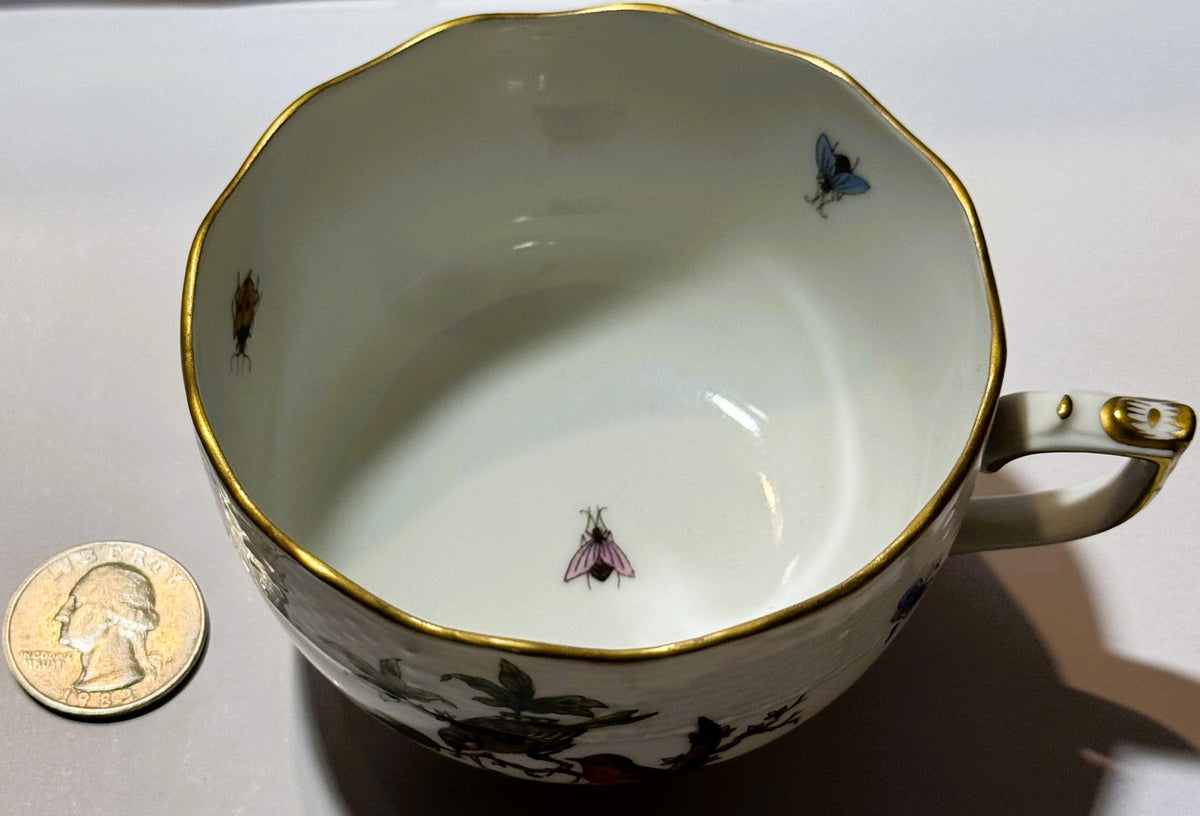 Herend porcelain teacup with hand-painted birds and insects, gold rim, shown next to quarter for scale