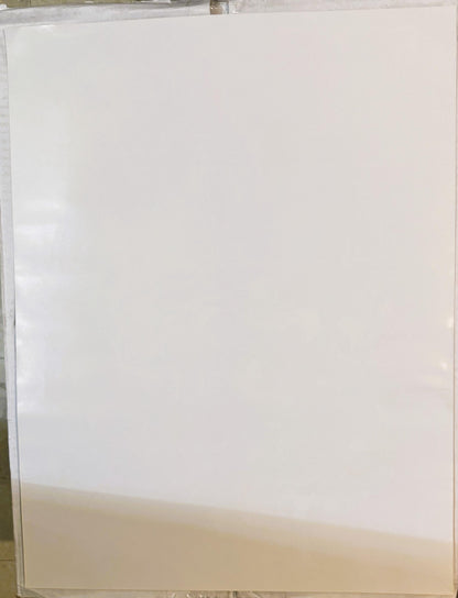 Blank cream-colored poster board leaning against a surface, showing the back or unprinted side