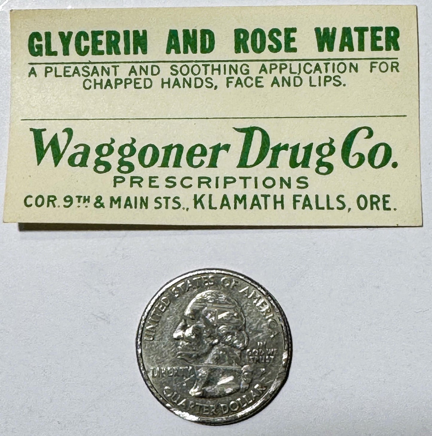 Vintage cream-colored label for glycerin and rose water from Waggoner Drug Co., Klamath Falls, Oregon, shown with a quarter c