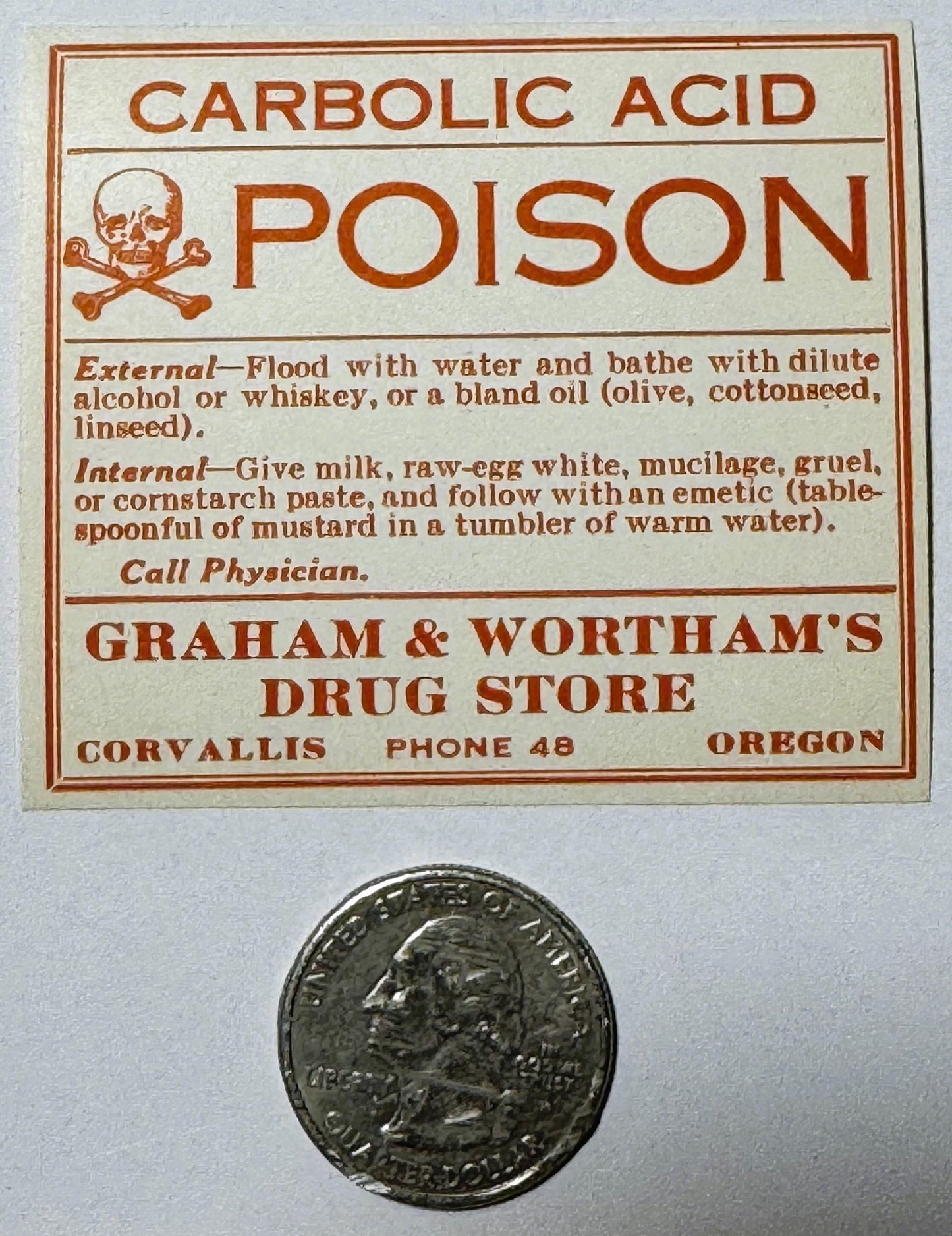 Vintage poison label with skull and crossbones, treatment instructions, and Corvallis Oregon drug store details, displayed ne