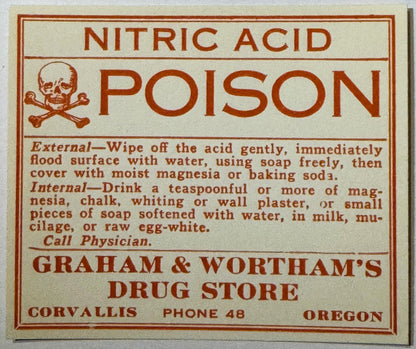 Vintage nitric acid poison warning label with skull and crossbones, red text on cream background, Graham & Wortham's Drug Sto