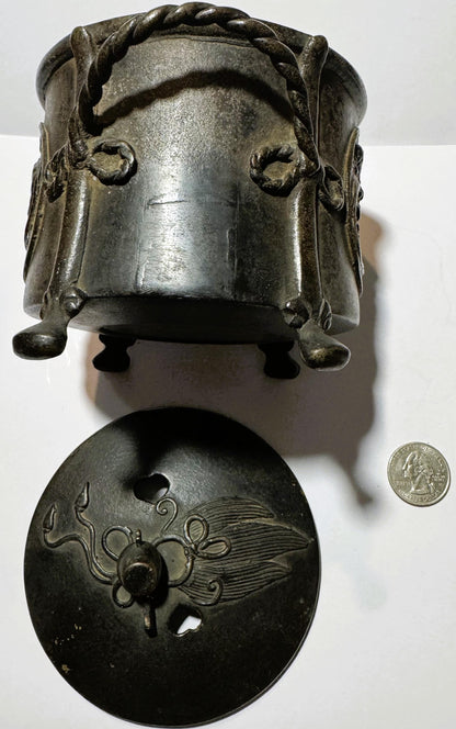 Antique bronze censer with facial features and twisted knot detail on lid, shown disassembled with base featuring dragon moti
