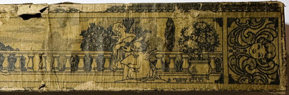 Aged piano roll with sepia-toned illustration showing woman holding child in garden setting with balustrade, decorative