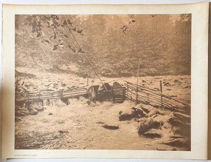 Sepia-toned photogravure showing a wooden fish trap structure by a stream with forest backdrop and rocky ground, labeled "HUP