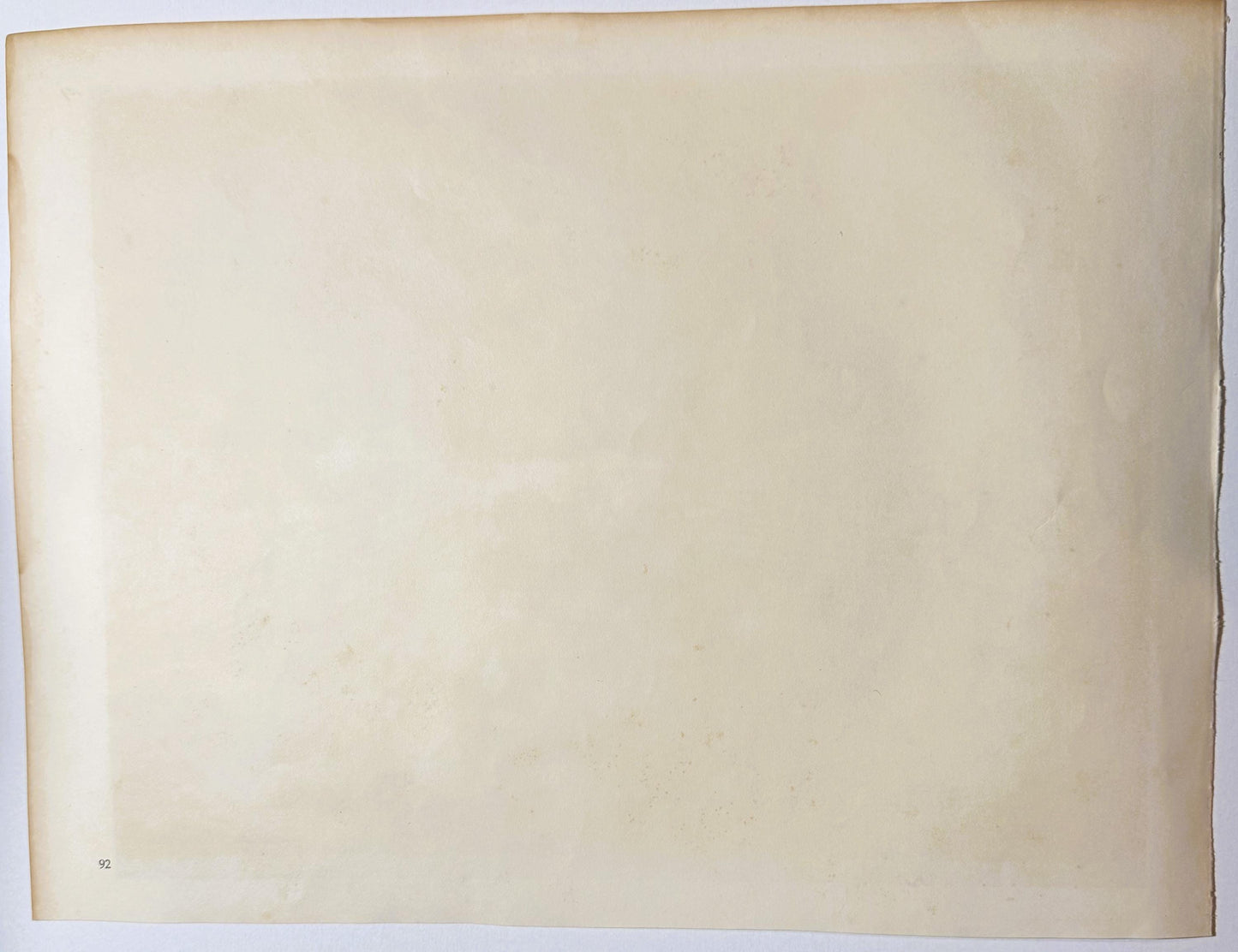 Blank cream-colored page numbered 92 in lower left corner, appears to be verso of antique book or photogravure publication