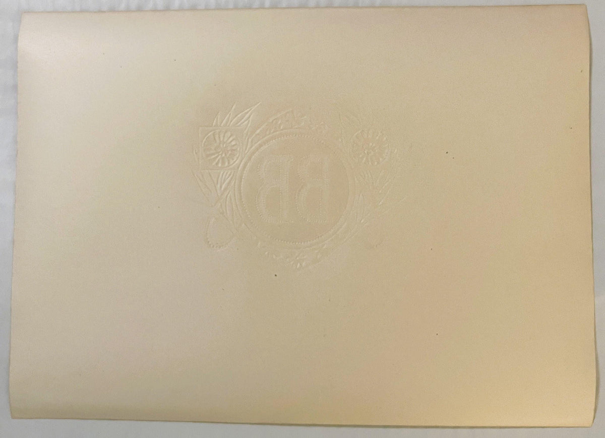 Back of the BB cigar label: plain cream paper with the BB monogram, flowers and leaves embossed through in reverse.