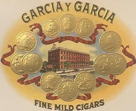 Antique cigar box label with "Garcia Y Garcia Fine Mild Cigars" text, factory building illustration, and gold coins arranged 