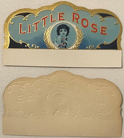 Two-piece antique cigar box label with gold embossed borders, blue top panel reading "LITTLE ROSE" in red letters with portra